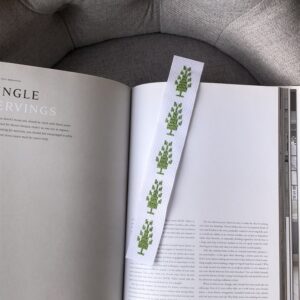 Bookmark stitched with green trees of life.