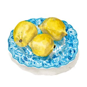 Three lemons on a blue porcelain plate.