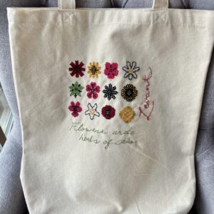 Tote bag stitched with colourful flowers.