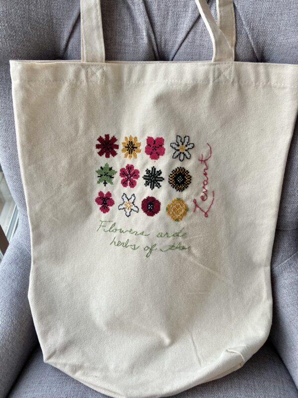 Tote bag stitched with colourful flowers.